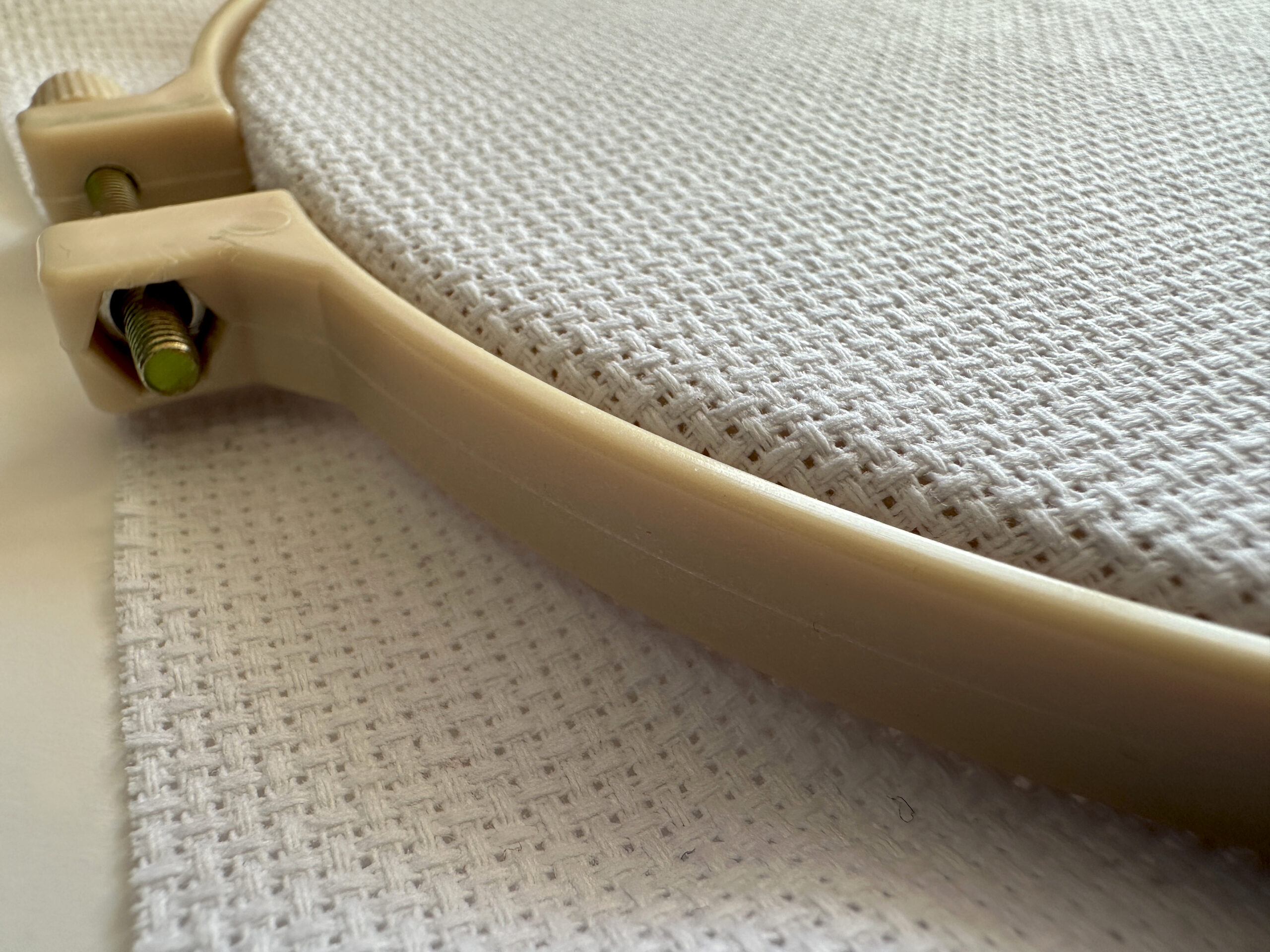 Close-up of an embroidery hoop with Aida cross stitch fabric